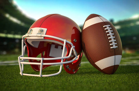 A red football helmet next to a football