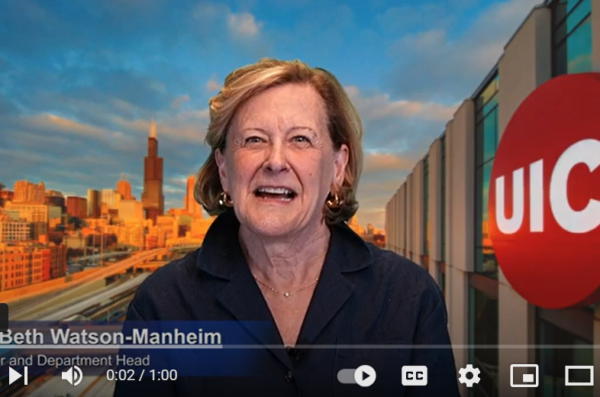 Mary Beth Watson-Manheim speaking to camera infront of Chicago and UIC skyline